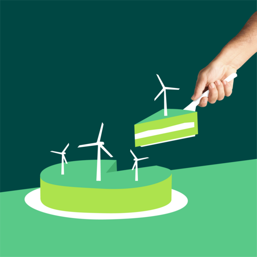 Hand nimmt sich ein Stück grünen Kuchen verziert mit Windrädern
