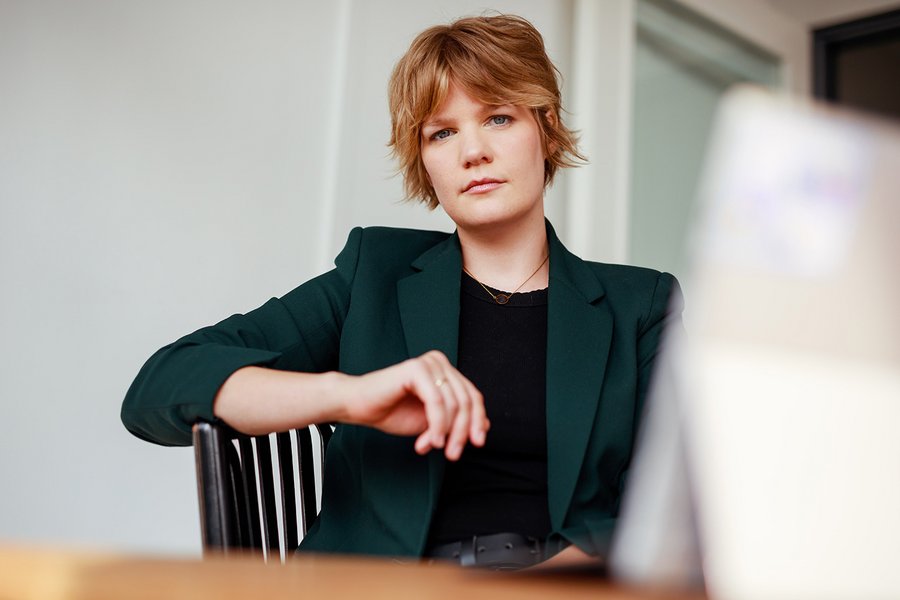 Ein Frau mit blonden Haaren und grünem Blazer